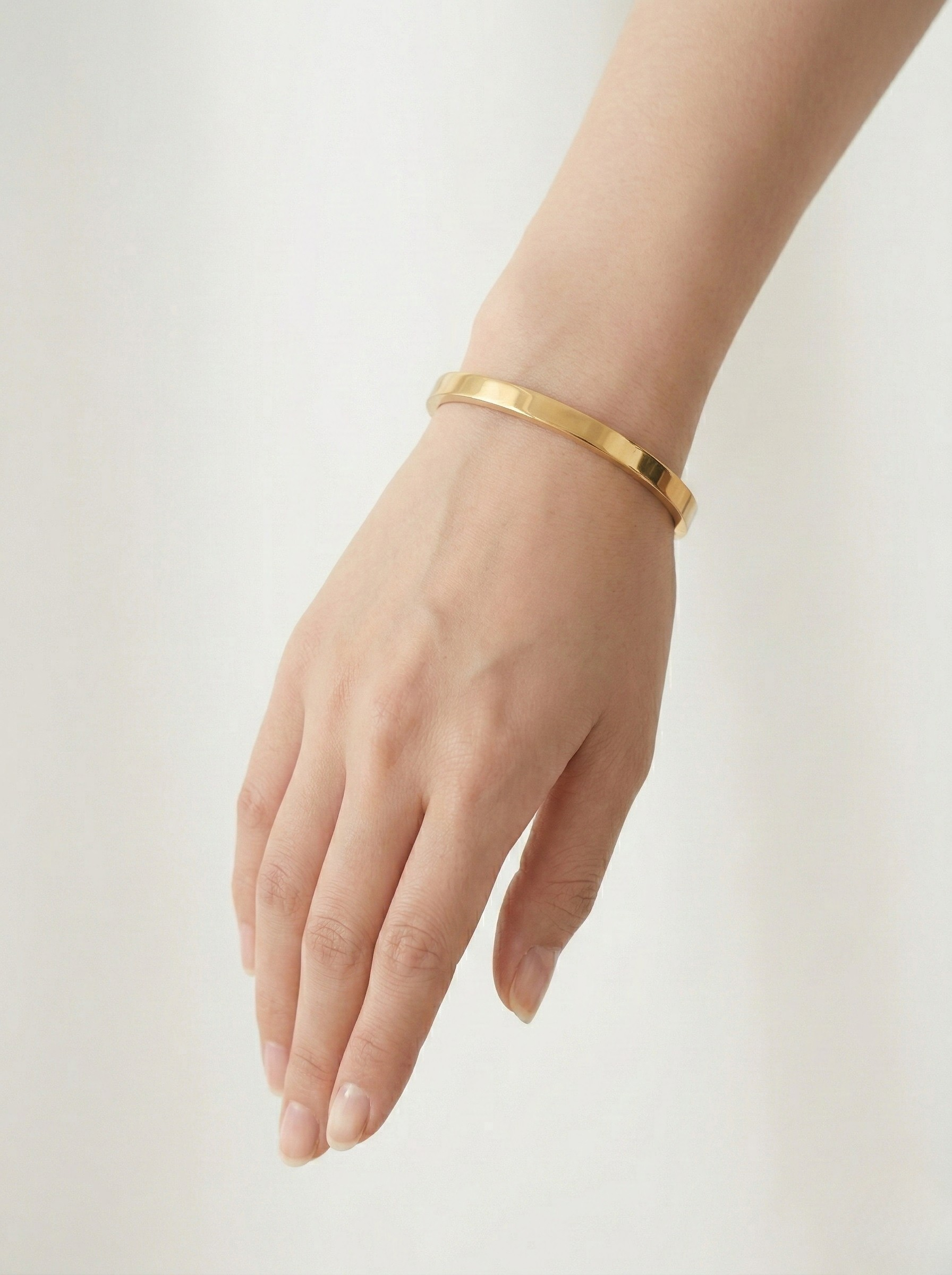 Elegant Gold Minimalist Bangle on Marble Surface