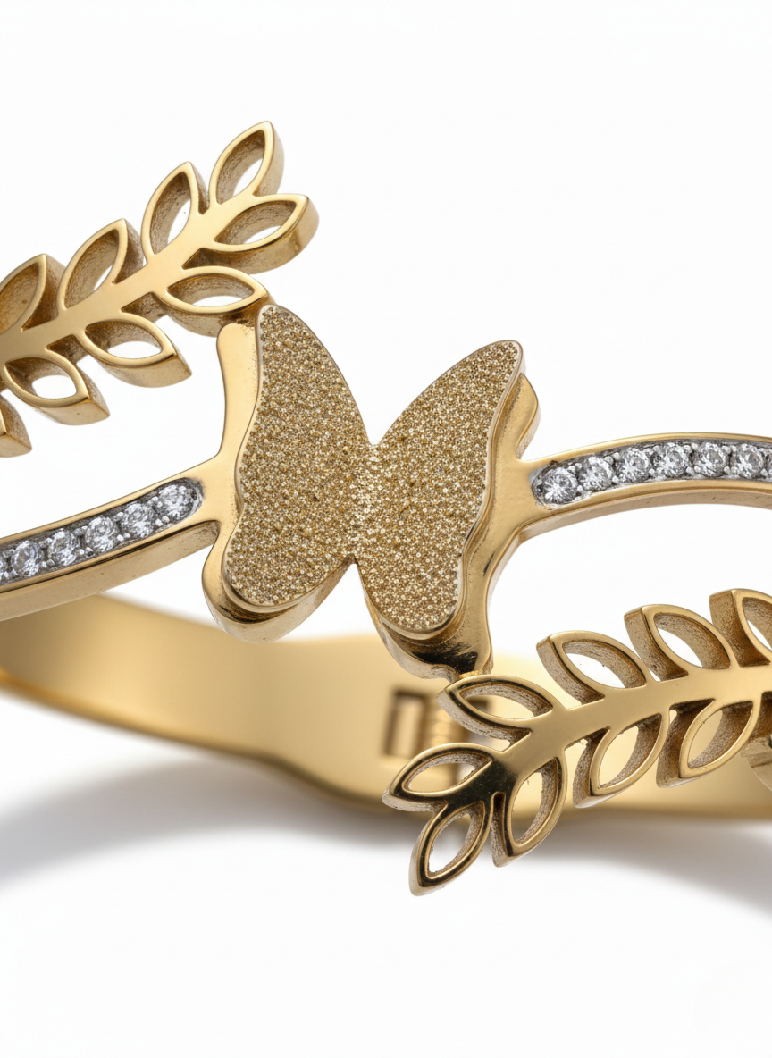 Elegant butterfly gold kada on marble flatlay.