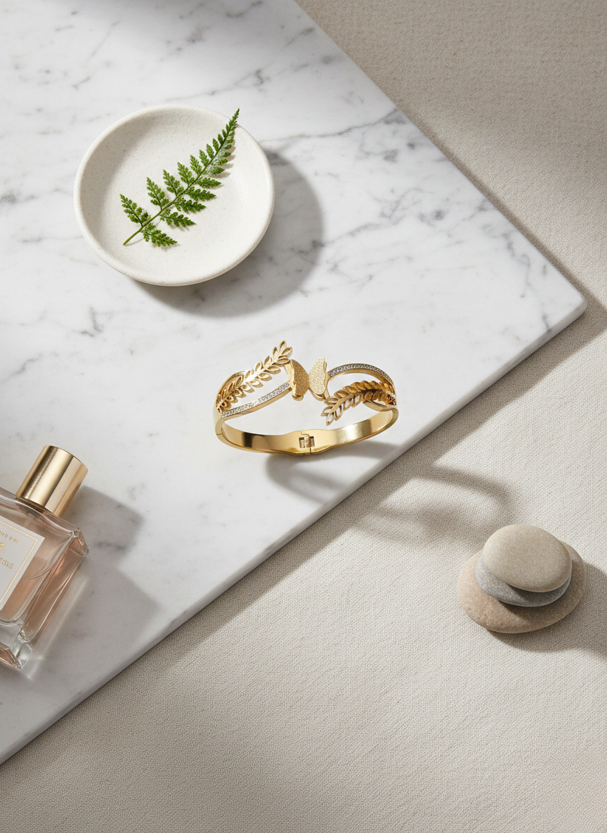 Elegant butterfly gold kada on marble flatlay.