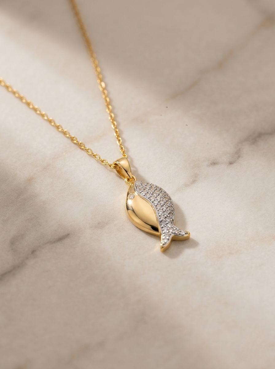 Elegant Gold Fish Pendant On Marble Surface