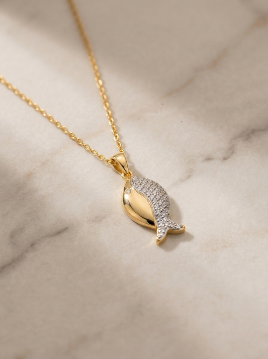 Elegant Gold Fish Pendant On Marble Surface