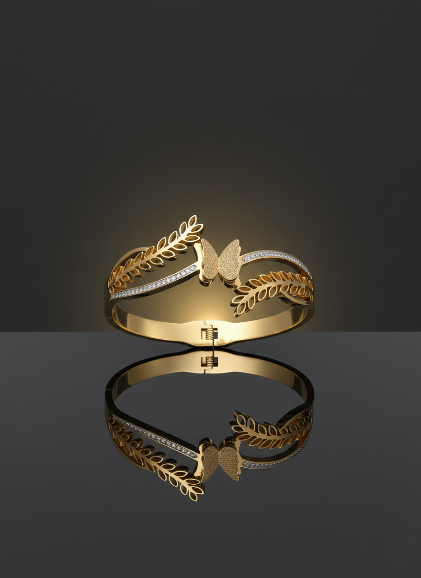Elegant butterfly gold kada on marble flatlay.