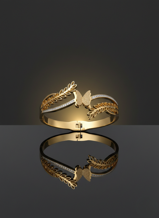 Elegant butterfly gold kada on marble flatlay.
