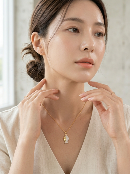 Elegant Gold Fish Pendant On Marble Surface