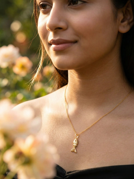 Golden Aquatic Elegance: Fish Pendant on Marble